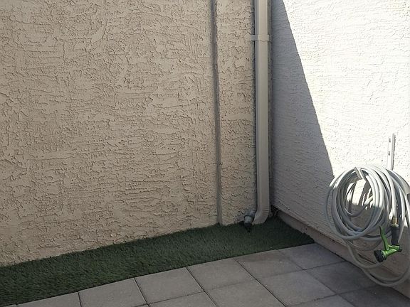 When entering BACK PATIO to left.
(Covered parking is behind back gate, your private entrance.)