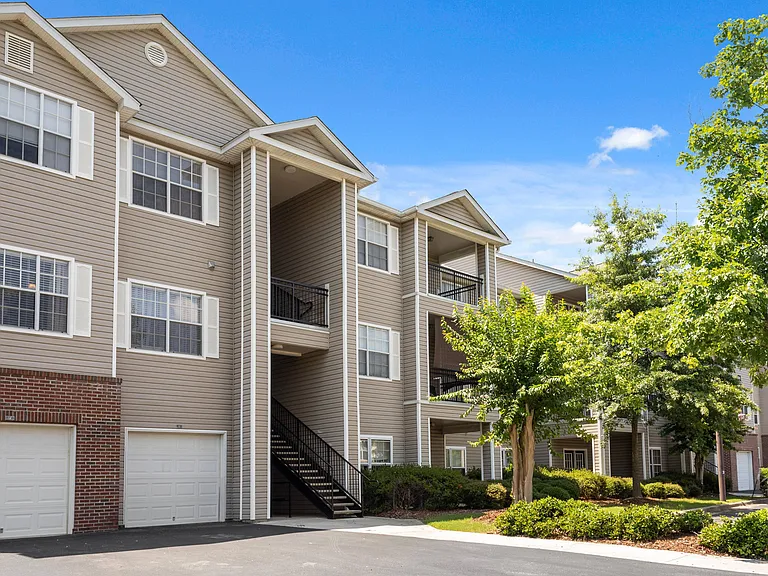 Landscaped Outside Apartment View with Attached Garages