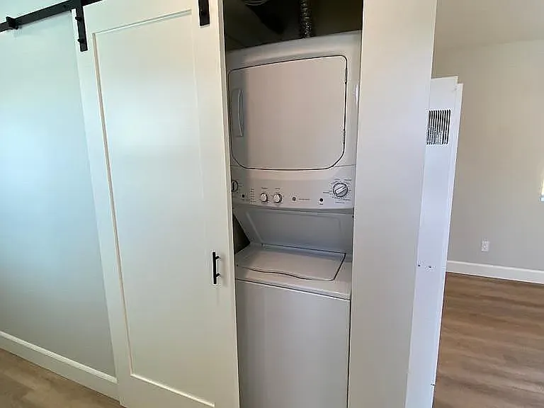 Full size stacked washer dryer, convenience inside location, barn door hides the laundry for your guests.