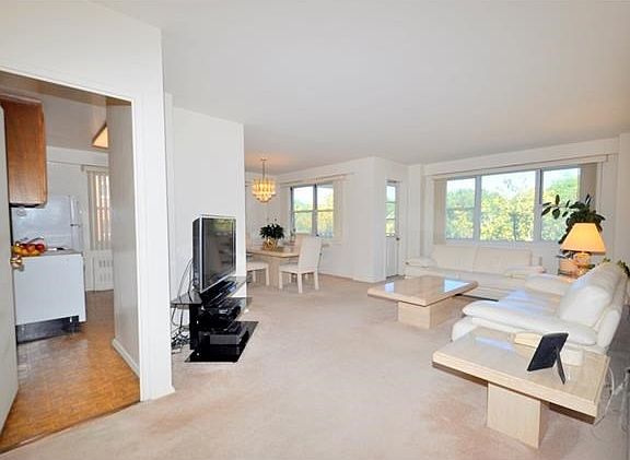 Bight and airy living room has sunny Eastern exposures.  The room has a door leading to a private balcony, great for enjoying the outdoors, and covered parquet floors.  The living room also open to a large entry foyer.  The living room is 20'-0" x 12'-0",