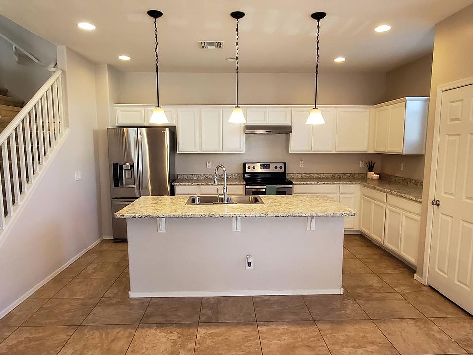 Modern kitchen with stainless steel appliances and white cabinets