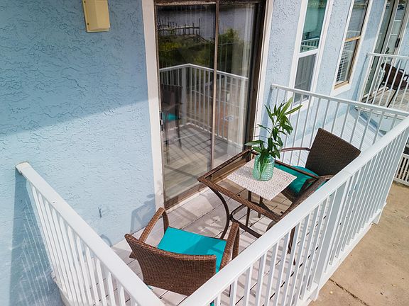 main floor balcony with bistro table perfect for morning coffee or evening wine.