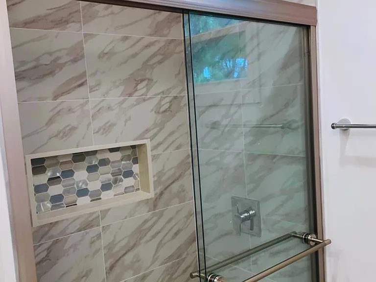 Generous and modern shower with integrated space for bathroom essentials. Lakeland, FL