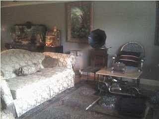 Large living room with high ceilings and tile floors