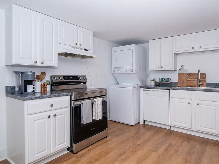 Fully equipped kitchen with new electric stove, deep Krauss sink and stainless steel faucet and functional dishwasher. In-unit washer and dryer.