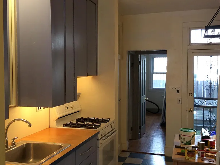 Kitchen with custom cabinets and door to bedroom and back yard patio