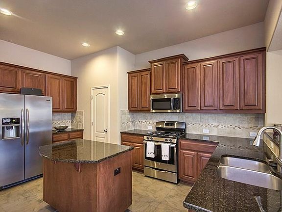 Chef's kitchen with stainless steel appliances, plenty of cabinet and counter space and an island