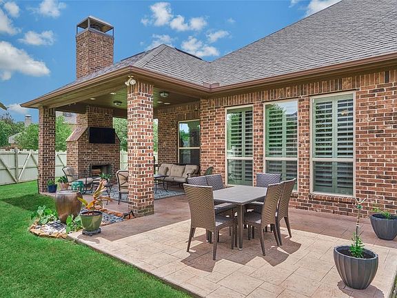 The covered patio and extension are finished with durable patterned concrete.