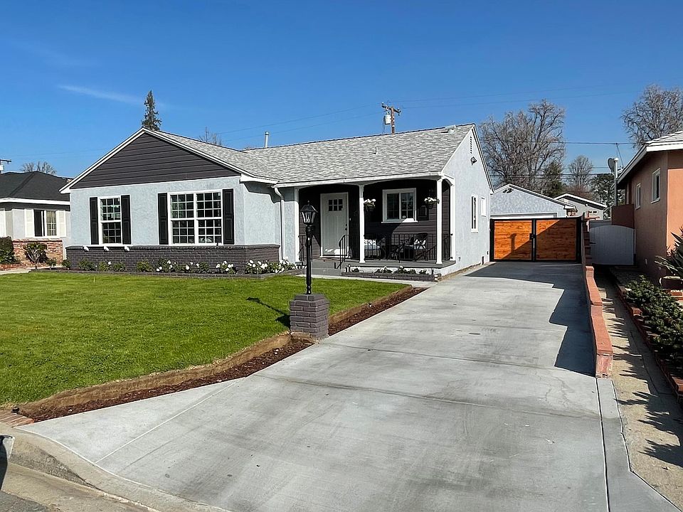 Front of home. Newly painted & manicured yard with sprinklers. New drive-way & gate for added privacy.