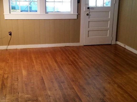 Living room with recently-uncovered and refinished hardwood.