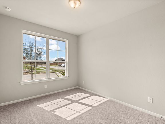 Your secondary bedroom features plush carpet, fresh paint, closet, and a large window that lets in p
