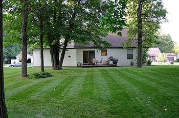 Private back yard with nice trees and deck.