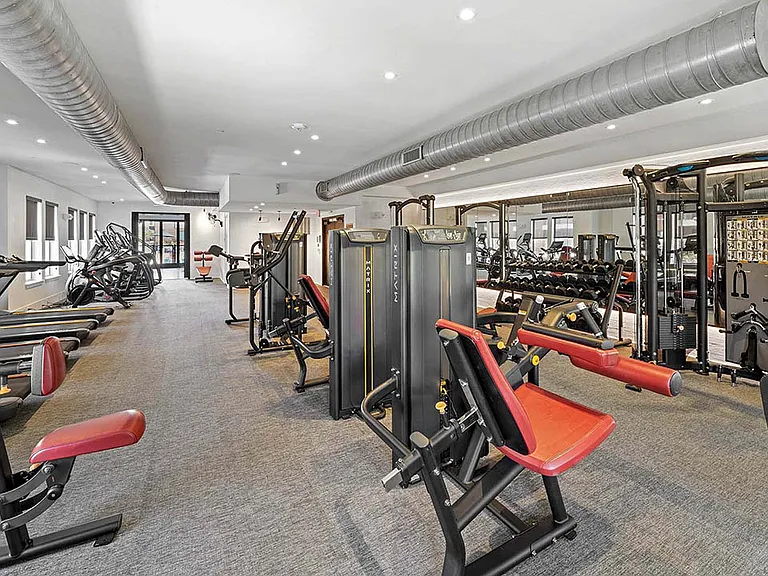 Fitness center with cardio machines and weight equipment.