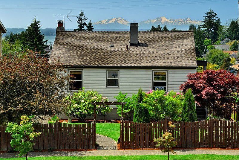 This sweet home is in the heart of the Alaska Junction. The front yard has nice established planting