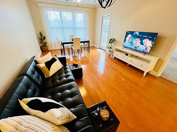 Up close living room and dining room. You can see the second bedroom door to the right of the TV, and the desk door to the left of the TV