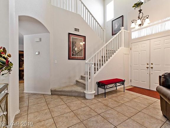 SPACIOUS OPEN FOYER  WITH HIGH CEILINGS LEADING TO FORMAL LIVING ROOM AND FAMILY ROOM