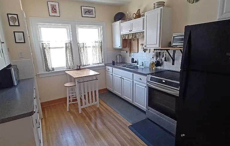 The kitchen has plenty of cabinet space, new induction range, full size refrigerator and microwave. Dishes and utensils provided.