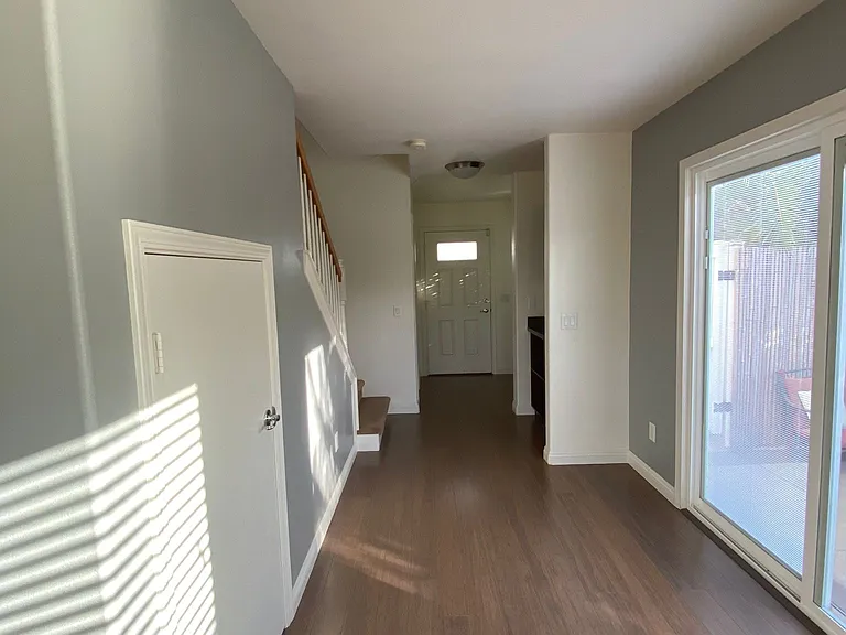 Front foyer with storage and sliding door to access yard