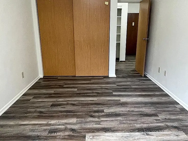 Step into sophisticated living at LS Capital Group. This spacious interior features elegant wood-style flooring and a modern layout, perfect for your personal touch. Elevate your lifestyle today and schedule a tour to see all that awaits!