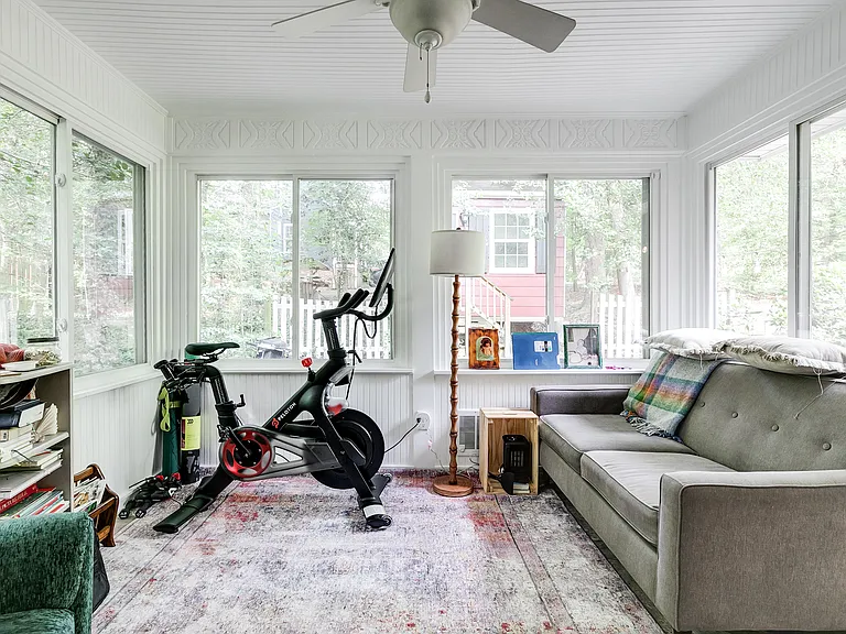 All season sunroom with wall to wall windows, ceiling fan and direct access to the back patio.