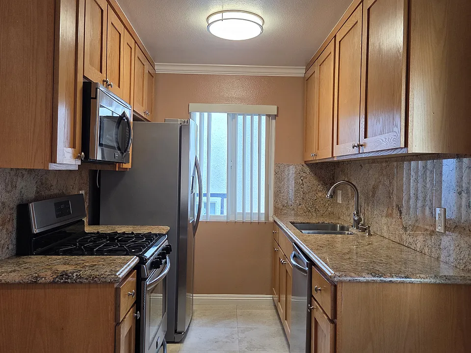 Custom kitchen with stainless appliances and granite counters
