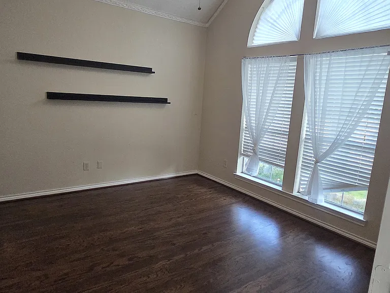 3rd bedroom or office downstairs with brand new wood flooring and modern ceiling fan.