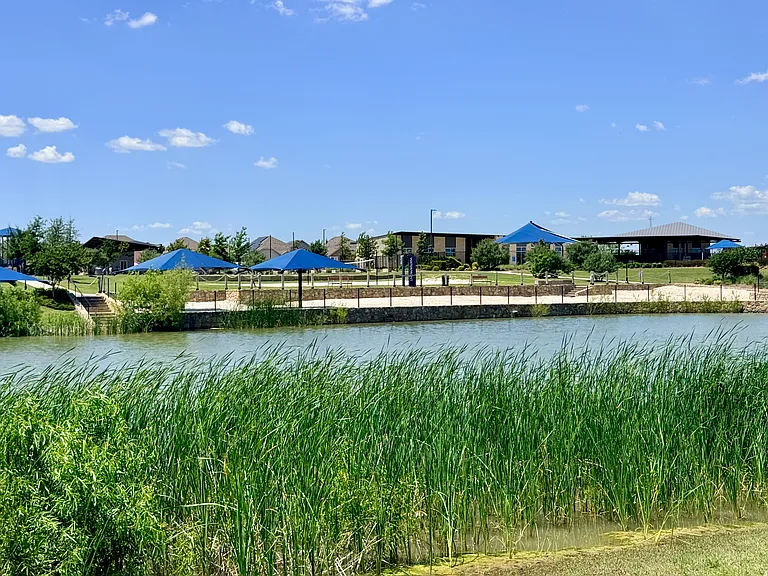 great amenity center with pool, games, sandy beach on the edge of lake