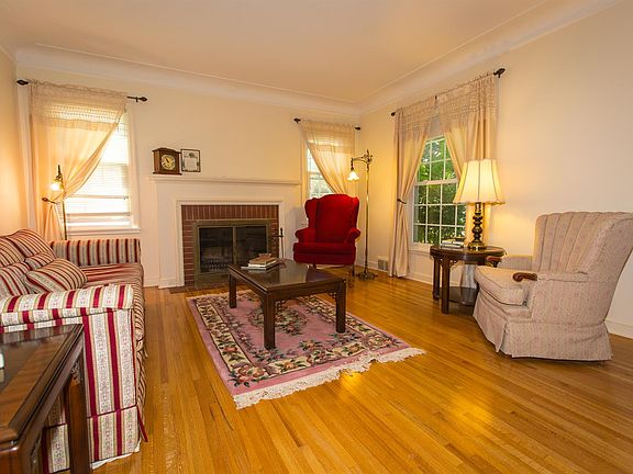 Gleaming hardwood floors and brick wood burning fireplace
