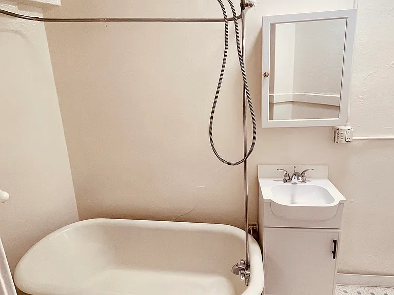 Bathroom with charming vintage tub/shower and tile floor, new vanity and cabinet