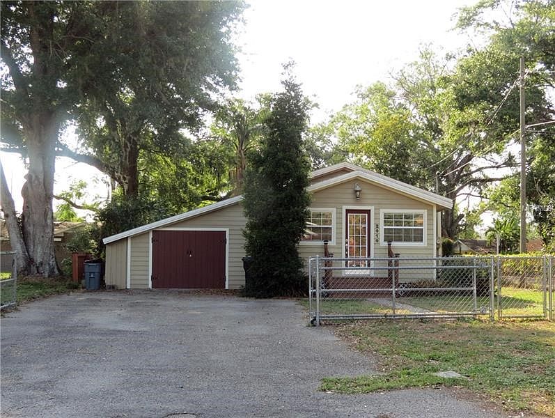 Front of house with parking for several cars