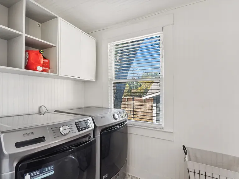 Laundry room located off the kitchen and leading to the backdoor. Window opens into the backyard. Washer/dryer are negotiable.