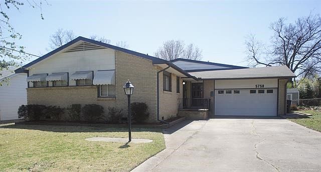 full brick, Midtown gem. Features sunroom, built in shop in garage and large family room.  Tons of space and flexibility.