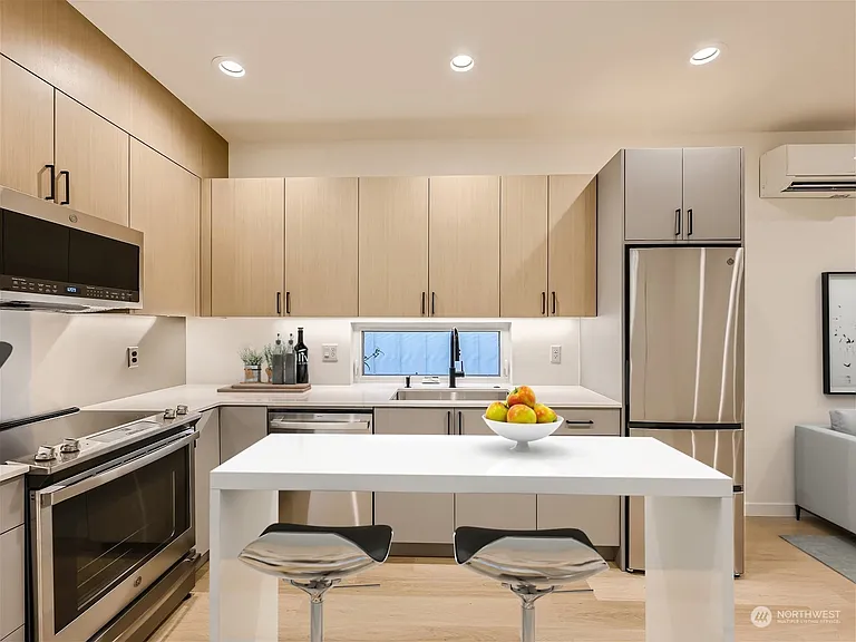 Kitchen. Fridge has been upgraded to an extra-large from pictured and cabinetry extended right 6 inches for additional storage!