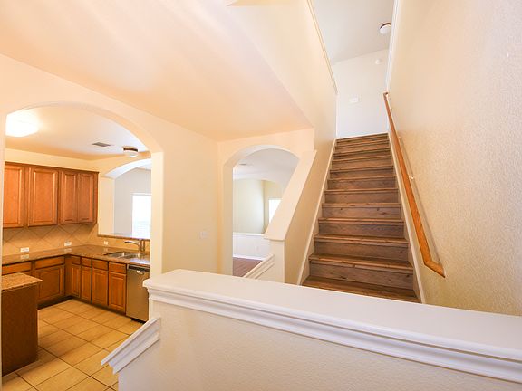 Entrance view of kitchen and staircase