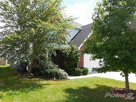 Lots of nice mature landscaping in front of the home.