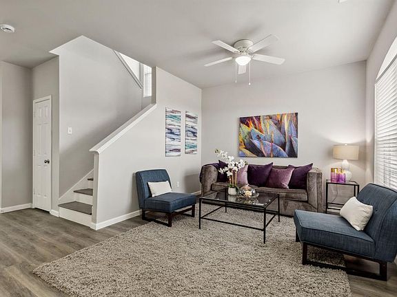 Living room featuring hardwood / wood-style flooring and ceiling fan
