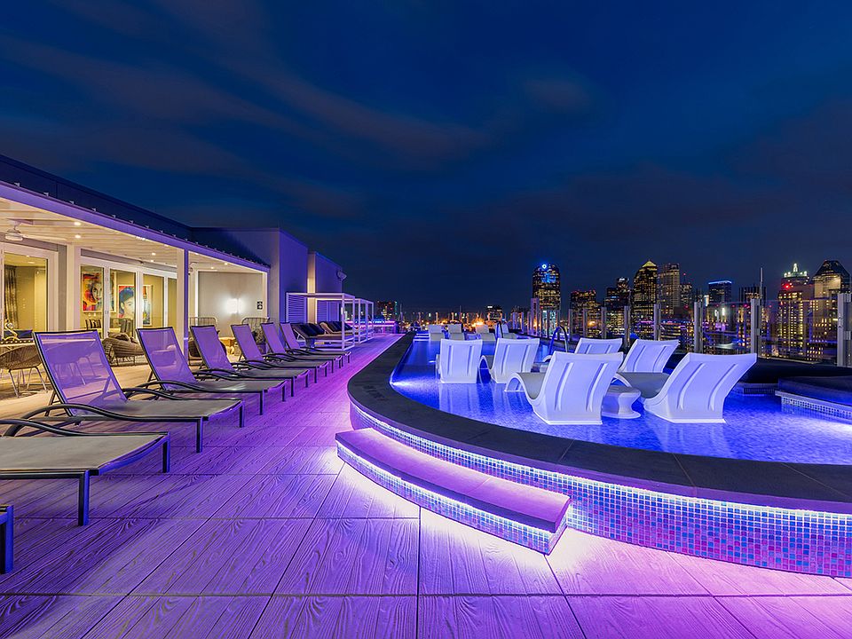 One UptowStunning rooftop pool with city views and lounge seating