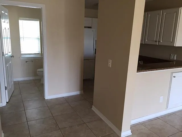 Adjacent to the living room lies a welcoming dining space and open kitchen featuring stove, fridge microwave and garbage disposal. A half bath sits off this space and includes a discreet closet spa stacked washer/dryer unit