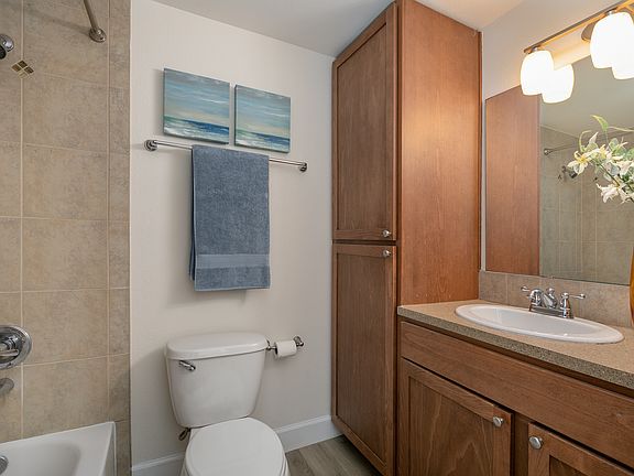 Inviting full bathroom with practical storage and neutral tones.