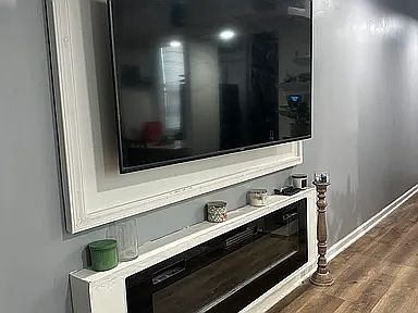 wall mount TV with functioning fireplace or just lighting for ambience.