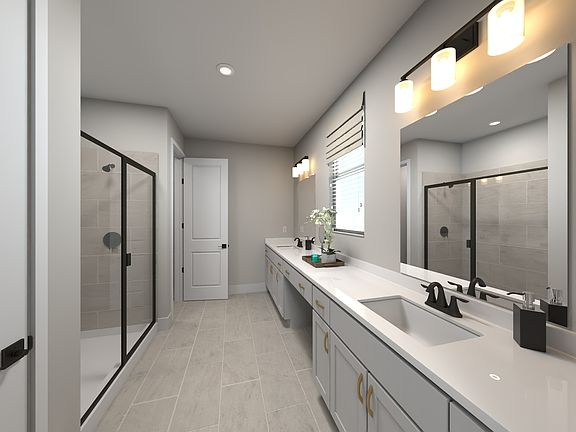 The primary bathroom offers dual vanity sinks and a walk-in shower.