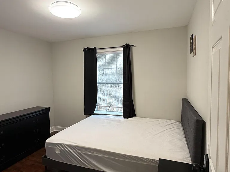 This room has a closet, nightstand, and a dresser with mirror!