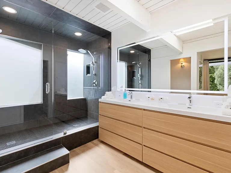 Newly remodeled primary bathroom with a spacious rain shower
