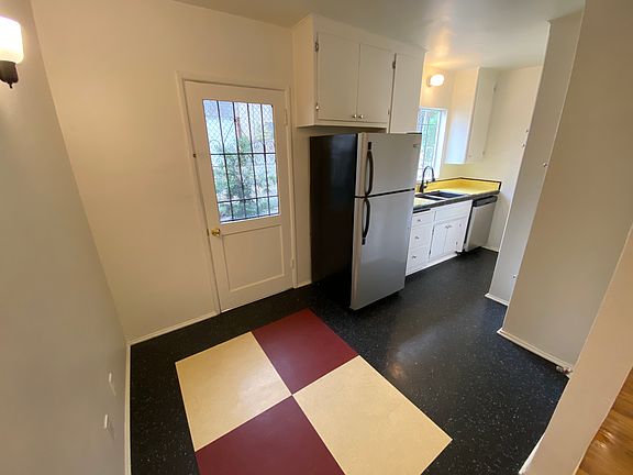 Dining area and kitchen with fridge, gas range and dishwasher