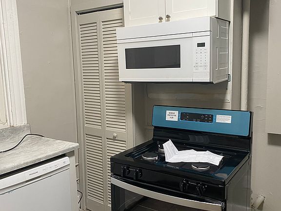 the white microwave has been replaced with a new stainless steel microwave.