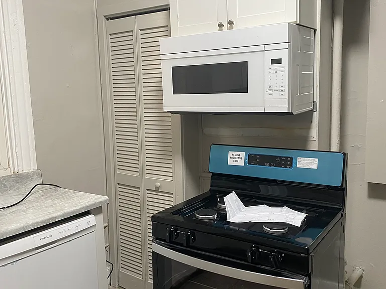 the white microwave has been replaced with a new stainless steel microwave.