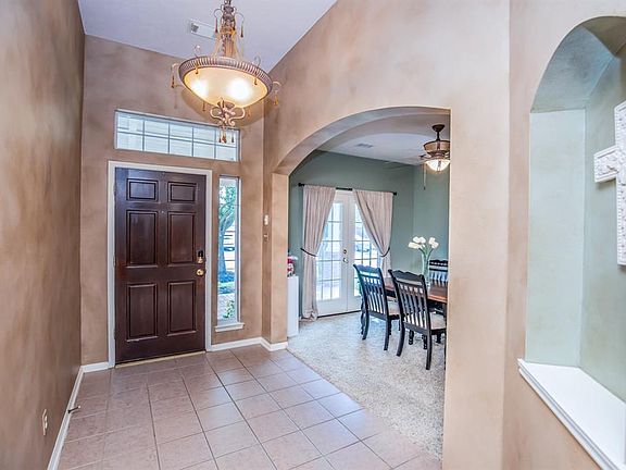 Formal foyer to welcome guests with elegant light fixtures and arches.