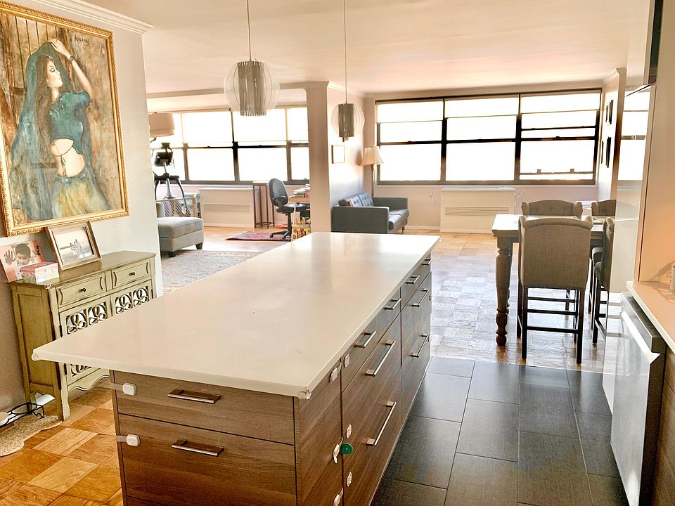 Open concept kitchen and living room. Seven windows ensure abundance of natural light throughout a day.