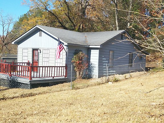 Side of house. Photo taken from adjacent empty, grassy maintained lot (which is owned by the neighbor).