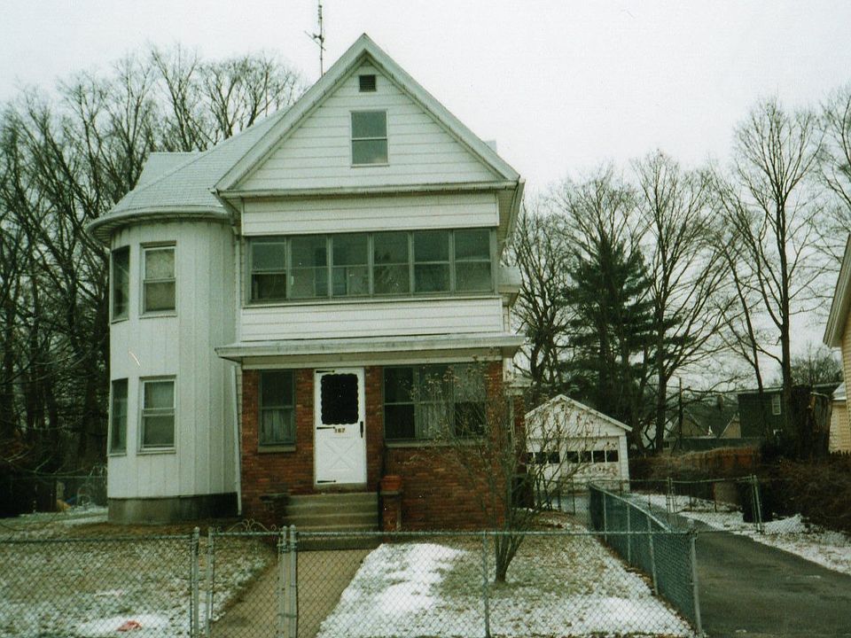 Front of house. unattached garage in backround.